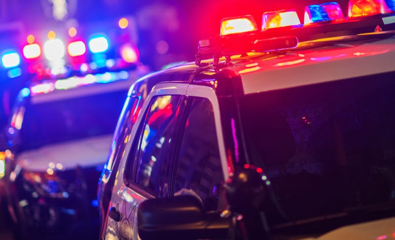 Police vehicles with flashing lights.