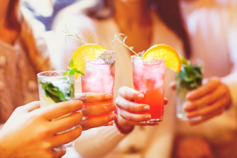 Young men and women drinking cocktails