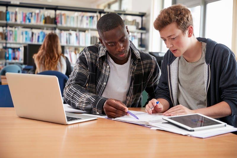 students studying at college library