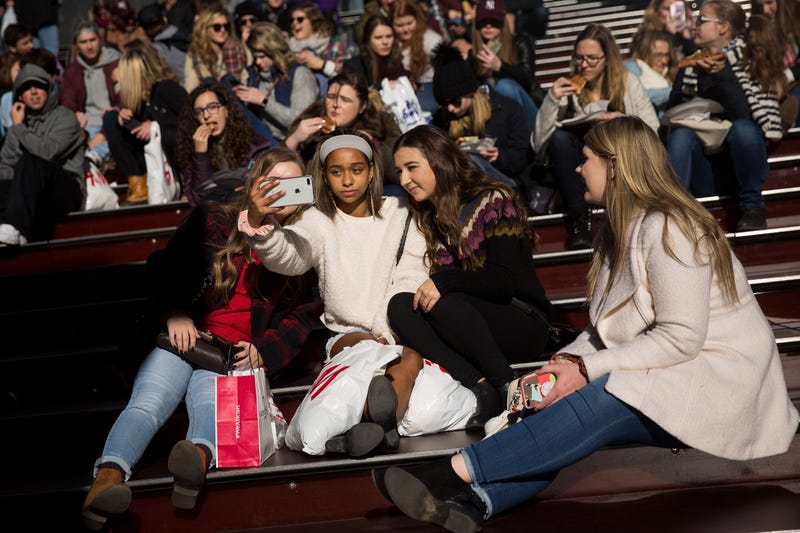 A group of teenagers take a selfie in New York City's Time Square