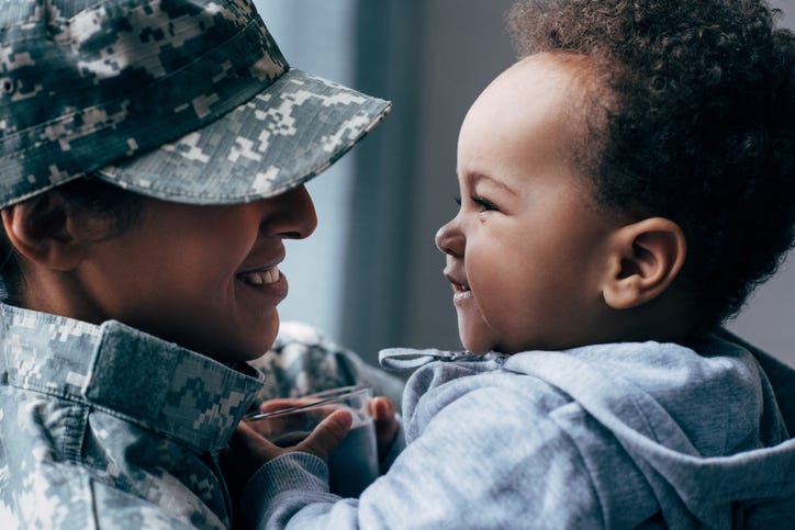 Army mom holding a baby