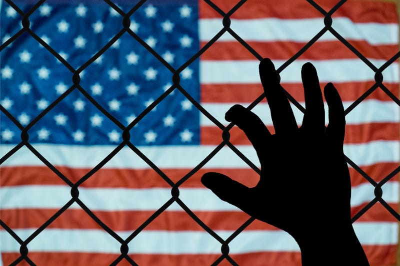 American flag seen through a fence