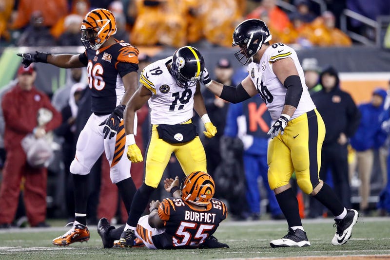 JuJu Smith-Schuster #19 of the Pittsburgh Steelers stands over Vontaze Burfict
