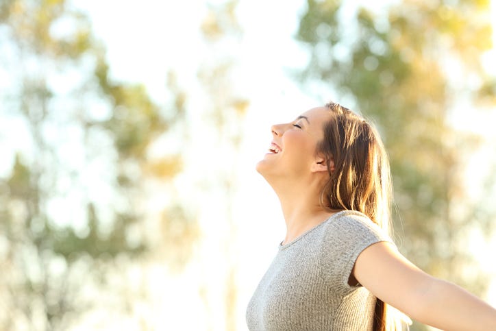 happy woman enjoying the outdoors on a nice day
