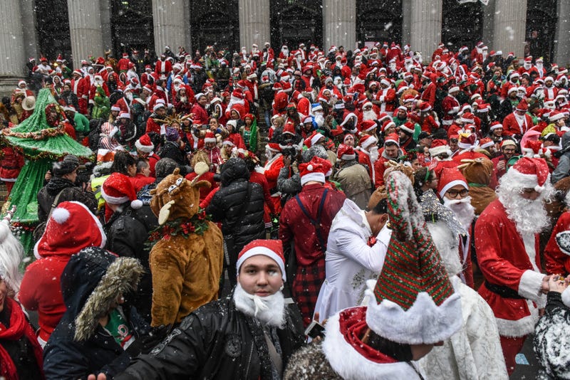 File photo: People dressed as Santa Claus participate in the annual bar crawl SantaCon in New York City