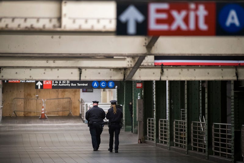 Police officers walk near the closed underground walkway near the site of a pipe bomb explosion in the tunnel that connects the Times Square subway station to the Port Authority Bus Terminal, December 11, 2017 in New York City.