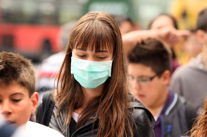 A woman wearing a surgical mask to prevent the transmission of airborne infection walks in Westminster on July 30, 2009 in London, England.