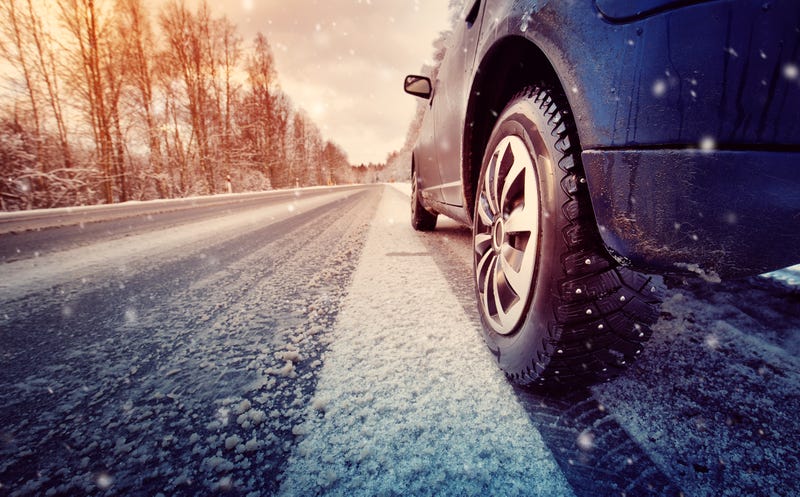 Snowy road and car tires