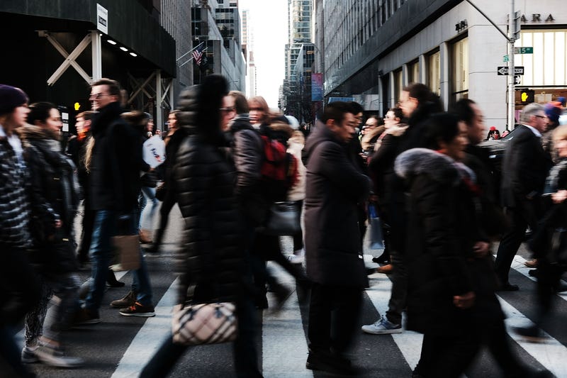 People walk by stores along Fifth Avenue during the holiday season