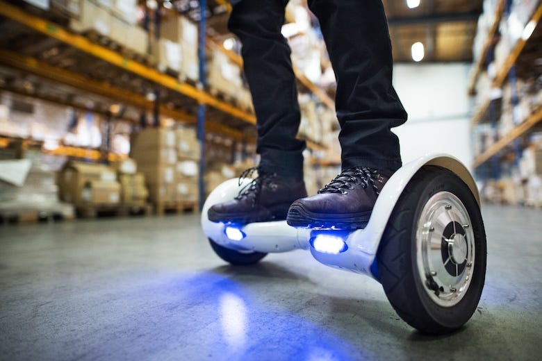 Man riding a hoverboard in a warehouse