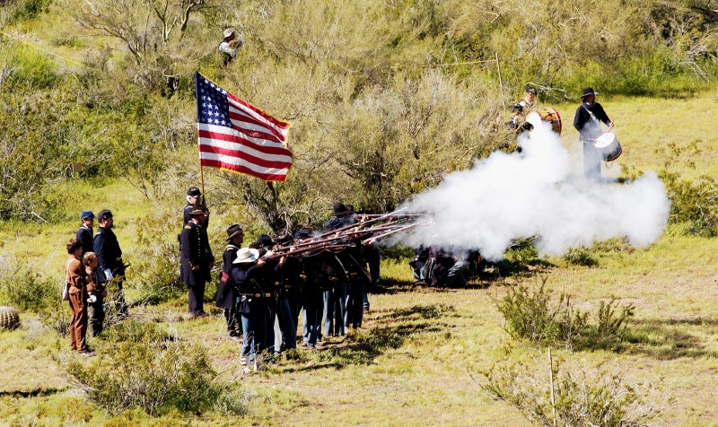 Civil War reenactors open fire.