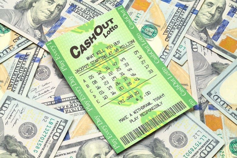 Lottery ticket sitting on a pile of cash