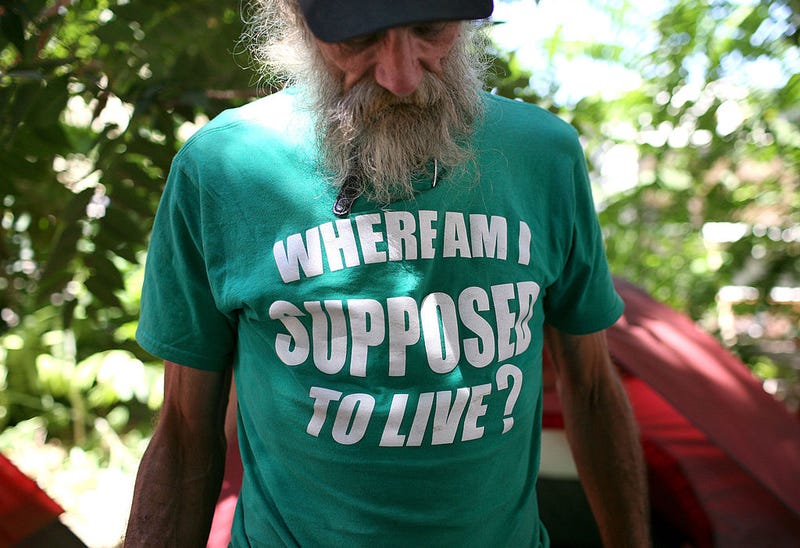 Homeless man John Kraintz stands in front of his tent in a "Safe Ground" encampment August 26, 2009 in Sacramento, California.