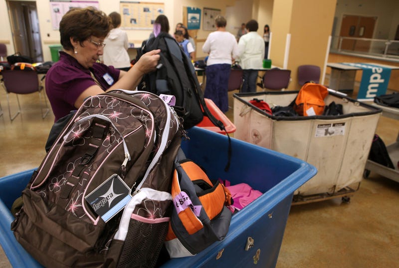 A volunteer at St. Anthony Foundation sorts through bins of backpacks filled with school supplies August 27, 2009 in San Francisco, California. 