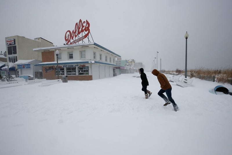 People run across the snow covered boardwalk, on January 4, 2018 in Rehoboth Beach, Delaware.