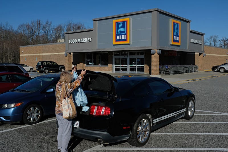 A shopper loads her car outside an Aldi discount grocery store on December 28, 2017 in Edgewood, Maryland.