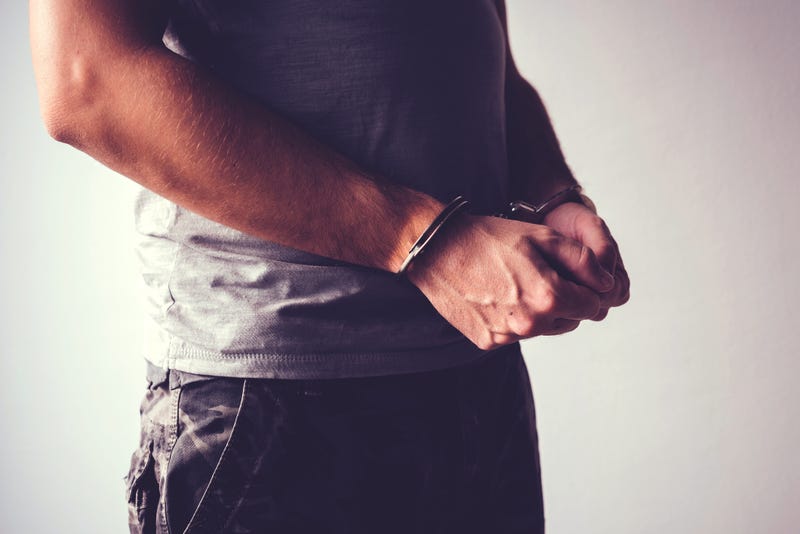 Man in army fatigues and handcuffs. 