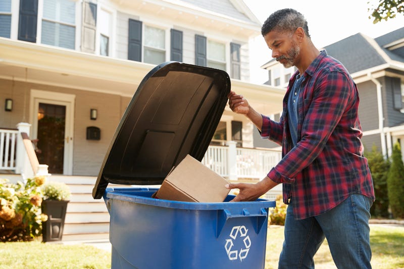 man recycling outside home