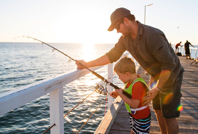 Father and son saltwater fishing - File Photo