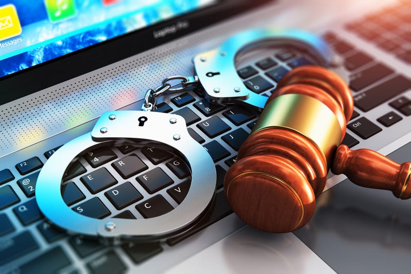 Stock photo of gavel, handcuffs and laptop