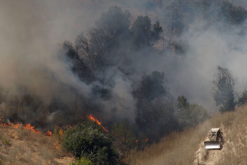 A firefighting bulldozer cuts a fire line on the southeastern flank of the nearly 10,000-acre Guiberson fire, burning out of control for a second day as Red Flag warnings continue in southern California on September 23, 2009 near Moorpark, California.