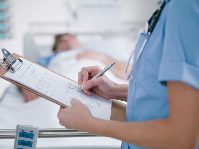 Nurse tending patient in intensive care