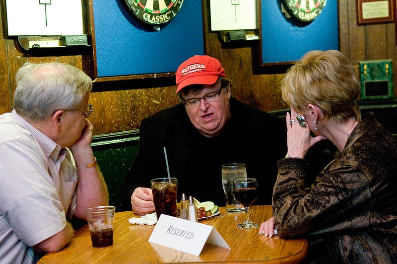 Director Michael Moore talks with a guests during a reception after the premiere of "Capitalism: A Love Story" at Ireland?s Four Courts on September 29, 2009 in Washington, DC. (Photo by Kris Connor/Getty Images)