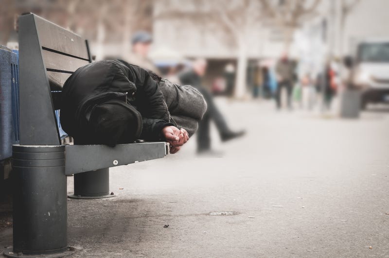 Generic photo of a homeless individual resting on a bench