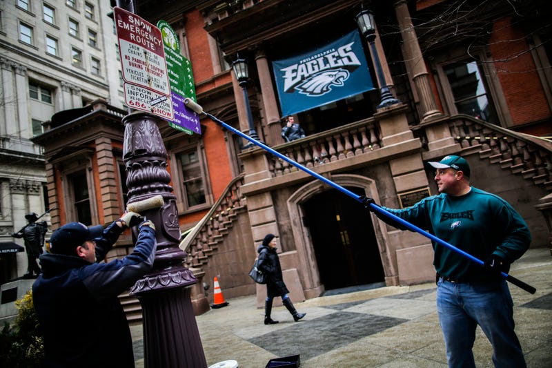 In Center City, Philadelphia police officers grease traffic light poles as a security measure for Super Bowl LII fans on Feb. 4, 2018.