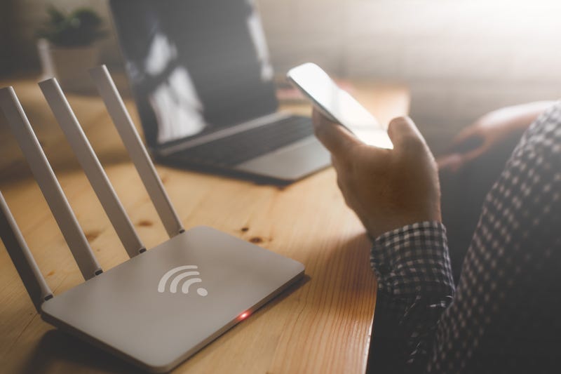 Internet router and person using phone
