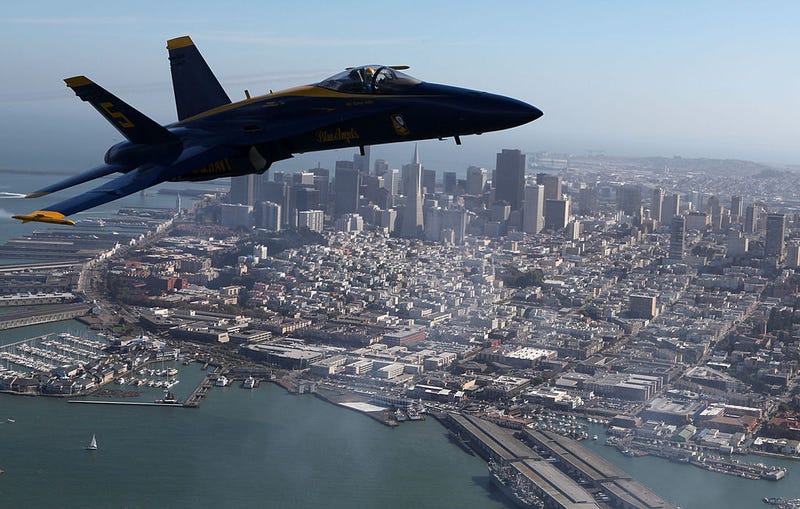 A U.S. Navy Blue Angels F/A-18 Hornet piloted by U.S. Marine Corps Major Nathan Miller flies past the San Francisco skyline during a practice flight ahead of the Fleet Week performance October 8, 2009 in San Francisco, California.