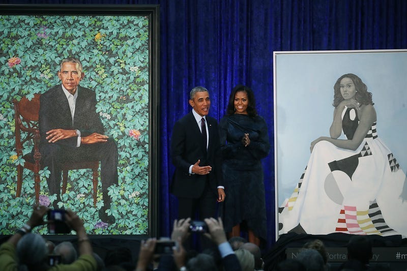 Former U.S. President Barack Obama and former first lady Michelle Obama stand next to their newly unveiled portraits during a ceremony at the Smithsonian's National Portrait Gallery, on February 12, 2018 in Washington, DC. The portraits were commissioned by the Gallery, for Kehinde Wiley to create President Obama's portrait, and Amy Sherald that of Michelle Obama. 