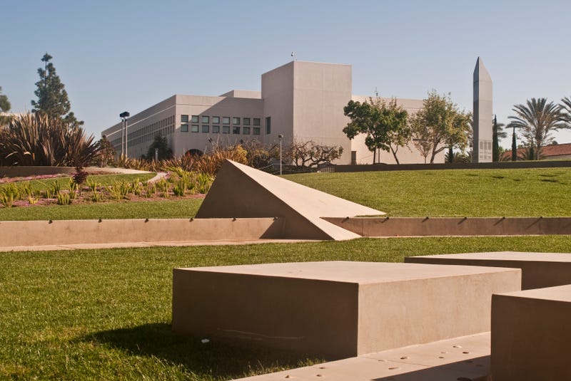 concrete geometric statues in yard outside university building