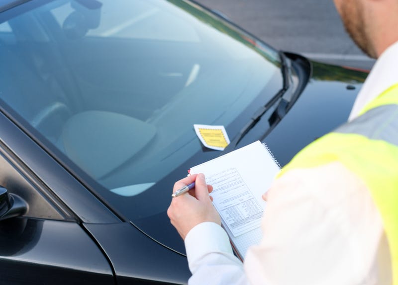 Police officer giving a ticket fine for parking violation