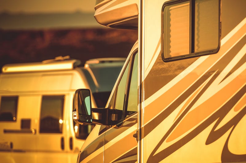 Two RVs at a RV park. 