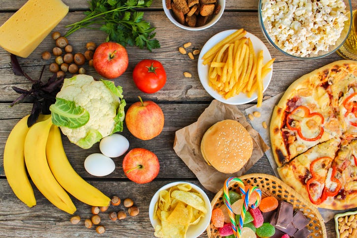 Healthy and unhealthy foods on a table. 