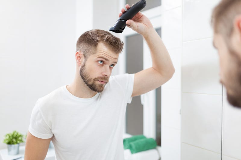 man cutting his own hair