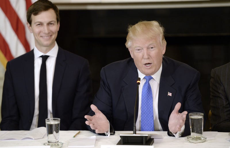 President Donald Trump speaks while Jared Kushner, senior White House advisor, left, smiles during a meeting with manufacturing executives in the State Dining Room of the White House in Washington, D.C., U.S., on Thursday, Feb. 23, 2017.