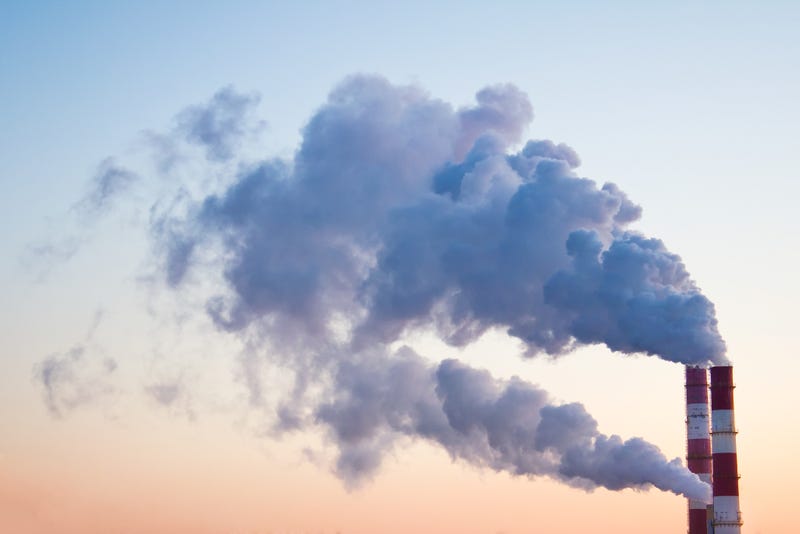 Smoke, fumes coming out of pipes of factory producing heat for central heating.