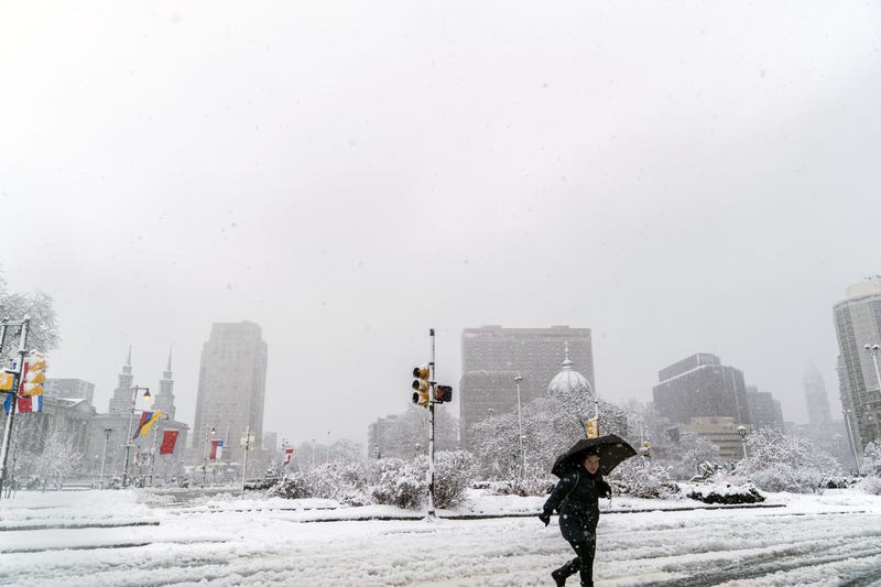 A pedestrian walks through snow and slush on March 7, 2018, in Philadelphia, the second nor'easter to hit the Northeast within a week.