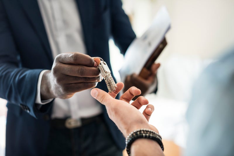 Landlord hands keys to a tenant.