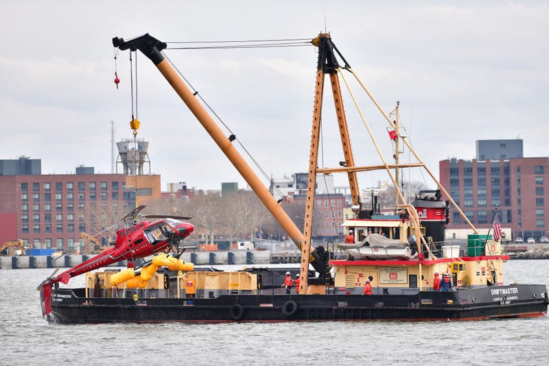A helicopter is pulled from the East River on March 12, 2018 in New York City. Five people died after the helicopter made an emergency landing and flipped upside down on Sunday night, trapping the passengers inside.