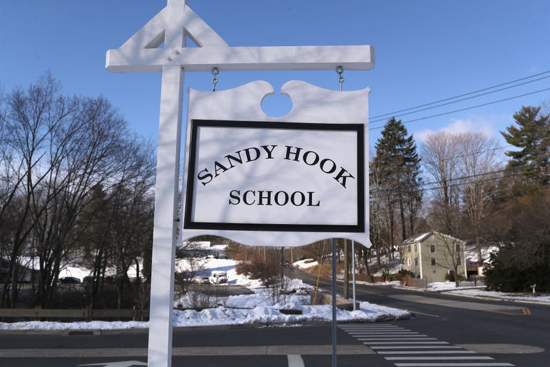 A sign stands near the site of the December 2012 Sandy Hook school shooting .