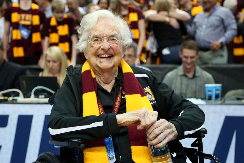 Sister Jean sitting in a basketball stadium