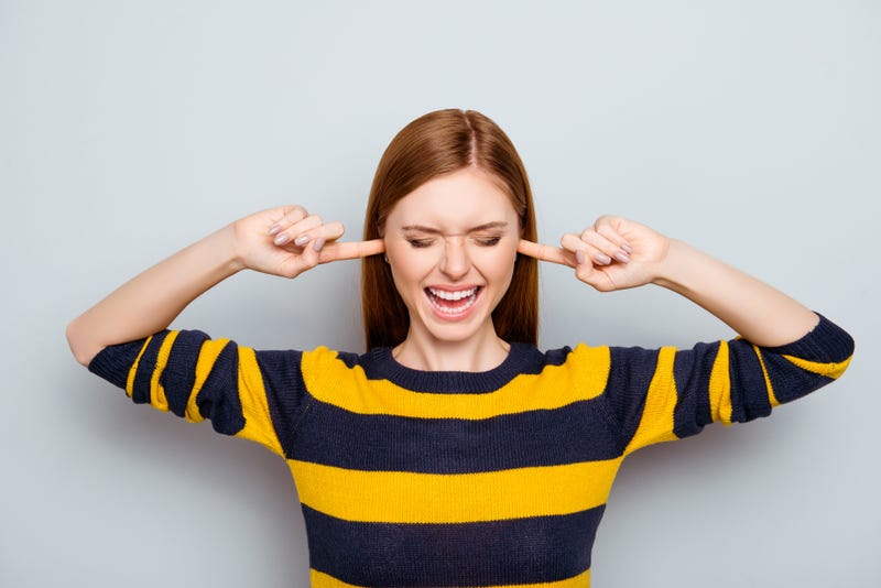 Woman plugging her ears