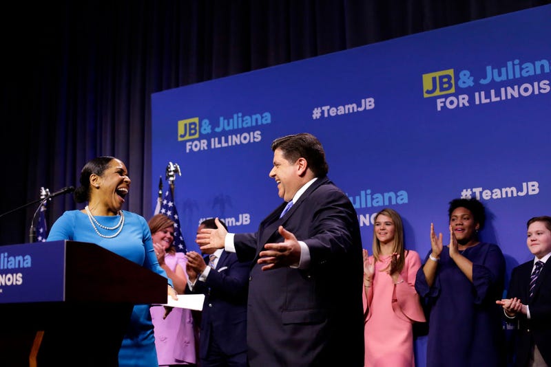 Illinois Democratic candidate for Governor J.B. Pritzker gesture towards his Lieutenant Governor pick Juliana Stratton for a hug during his primary election night victory speech on March 20, 2018 in Chicago, Illinois. Pritzker won the democratic primary against challengers Chris Kennedy and Daniel Bliss in the governor's race.