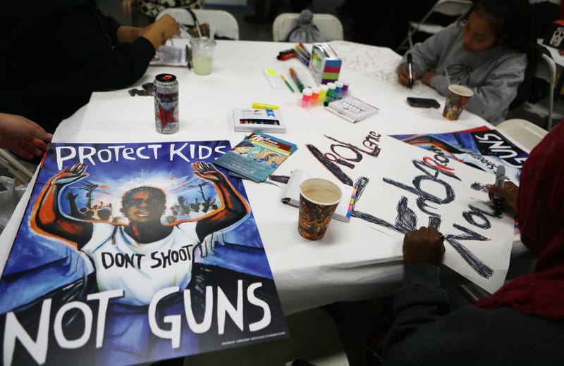 Young activists paint signs to be carried at the upcoming March for Our Lives Los Angeles on March 22, 2018 in Los Angeles, California.