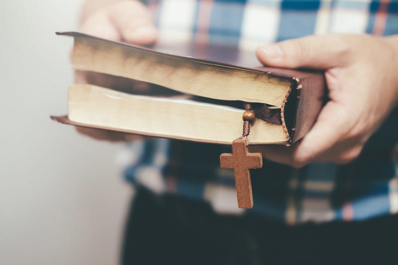 Man holding and reading the holy Christian Bible.