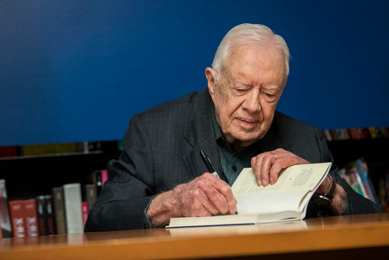 U.S. President Jimmy Carter signs a copy of his new book 'Faith: A Journey For All' at a book signing event at Barnes & Noble bookstore in Midtown Manhattan, March 26, 2018 in New York City. Carter, 93, has been a prolific author since leaving office in 1981, publishing dozens of books. (Photo by Drew Angerer/Getty Images)