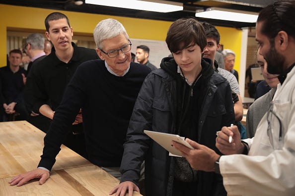 Apple CEO Tim Cook gets a demonstration of an app during an event held to introduce the new 9.7-inch Apple iPad at Lane Tech College Prep High School on March 27, 2018 in Chicago, Illinois. The device will work with Apple Pencil and is available now. (Photo by Scott Olson/Getty Images)